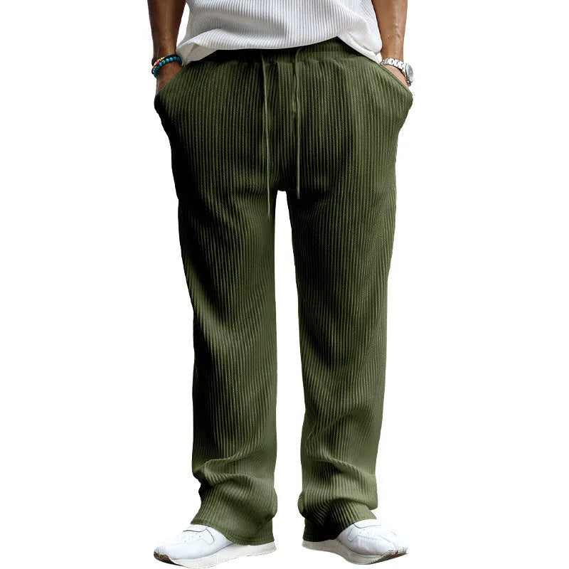 Men's loose straight leg striped casual trousers in army green on a plain background