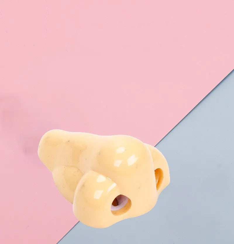 Flesh-coloured geometric pencil sharpener with a big hole for large pencils on a white background.