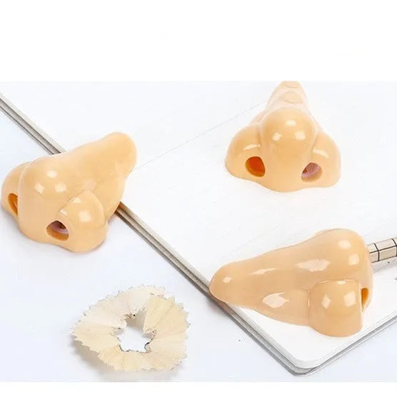 Flesh-coloured geometric pencil sharpener with a big hole for large pencils on a white background.