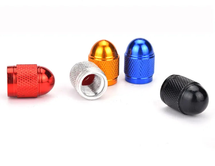 Aluminium alloy mountain bike tyre valve dust cap in silver, gold, red, blue, and black colours.