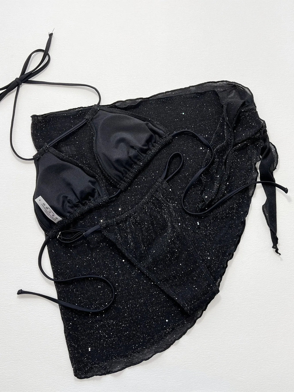 Black three piece bikini swimsuit set with a top and shorts on a mannequin.