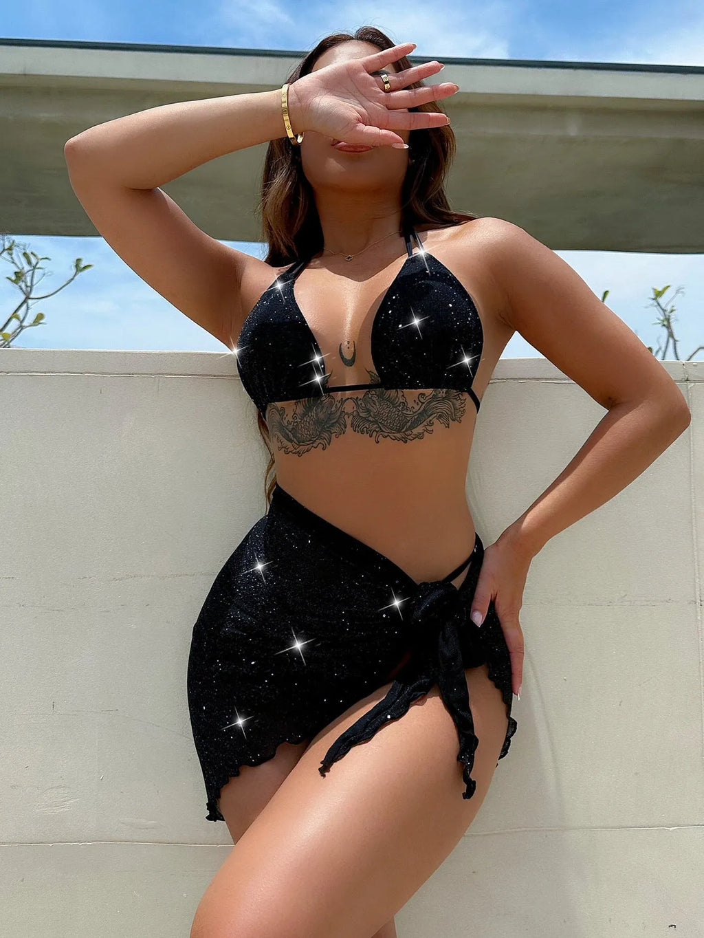 Black three piece bikini swimsuit set with a top and shorts on a mannequin.