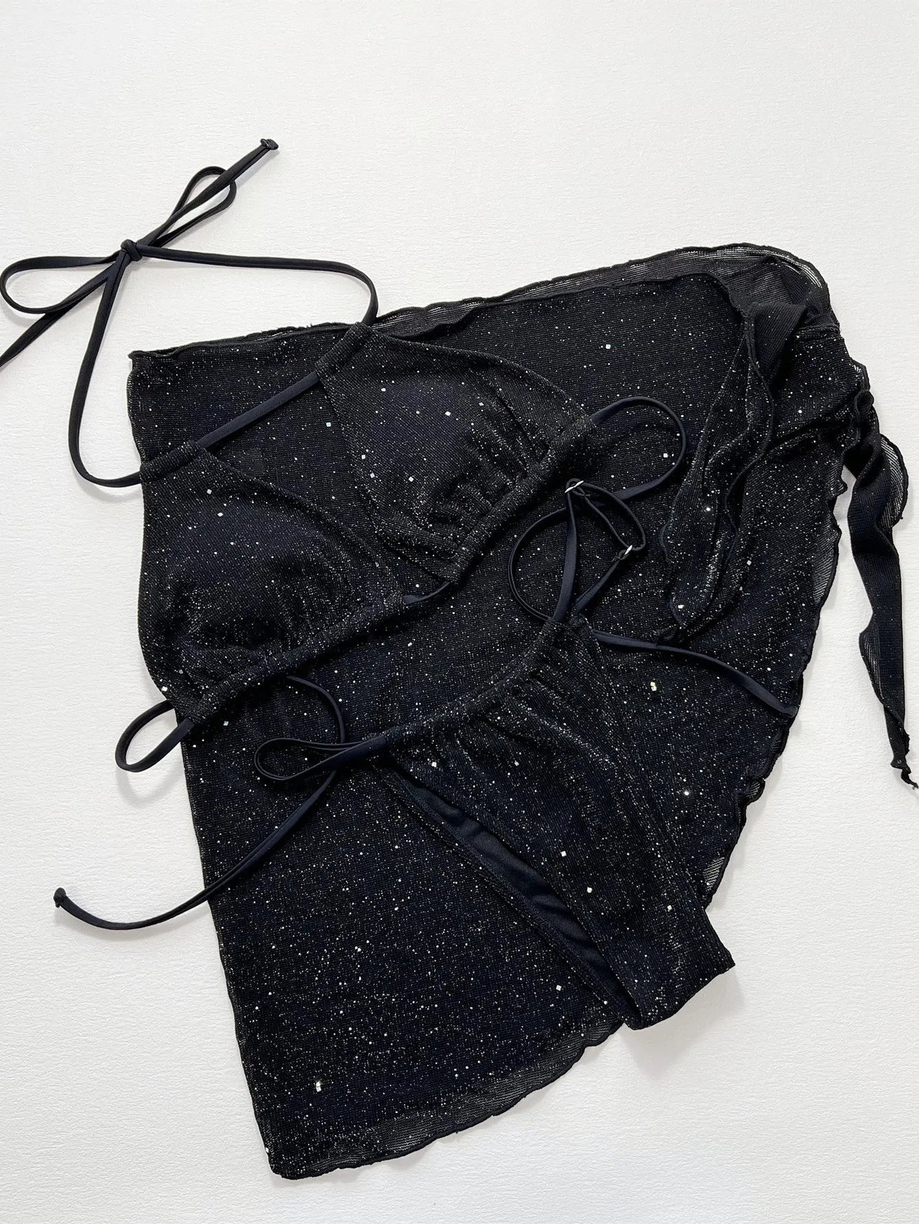 Black three piece bikini swimsuit set with a top and shorts on a mannequin.