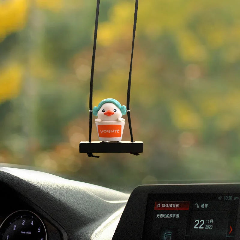 Yellow plastic duck doll car hanging ornament shown in four design variations.