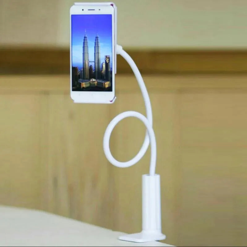 Black bedside phone handset with a long aluminium arm holding a mobile phone on a table.