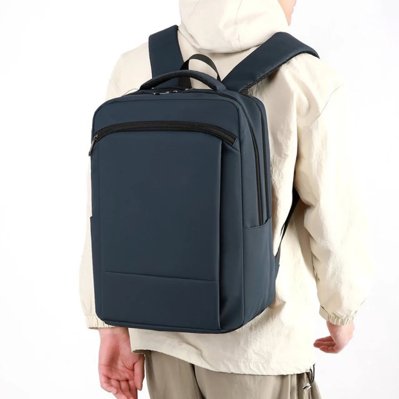Gray casual business commute computer backpack with large capacity and curved shoulder straps on plain background