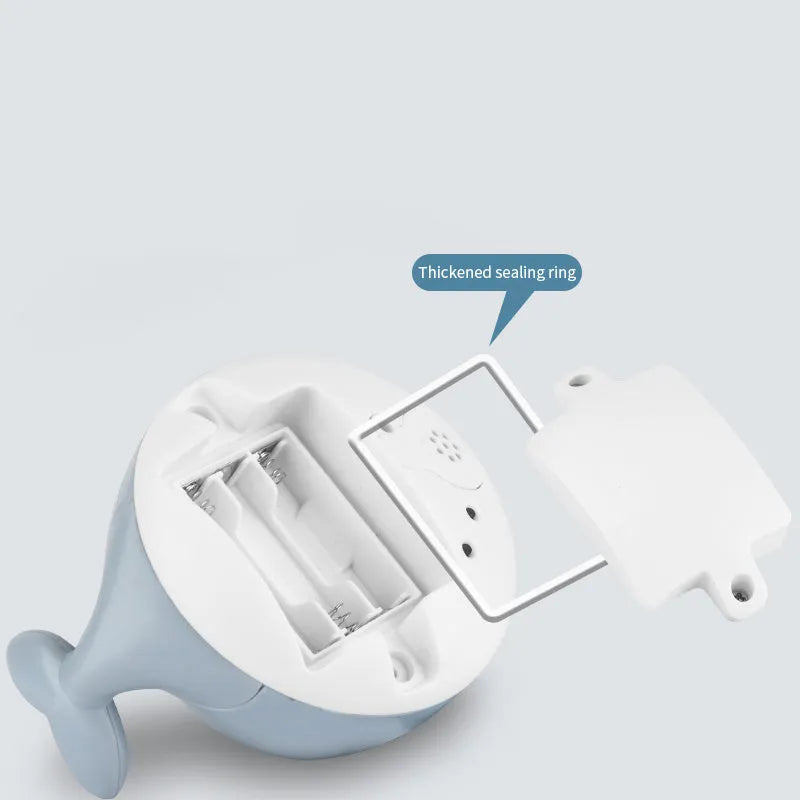 Whale-shaped electric bath toy with automatic water spray, LED lights, and music functions for baby sensory development