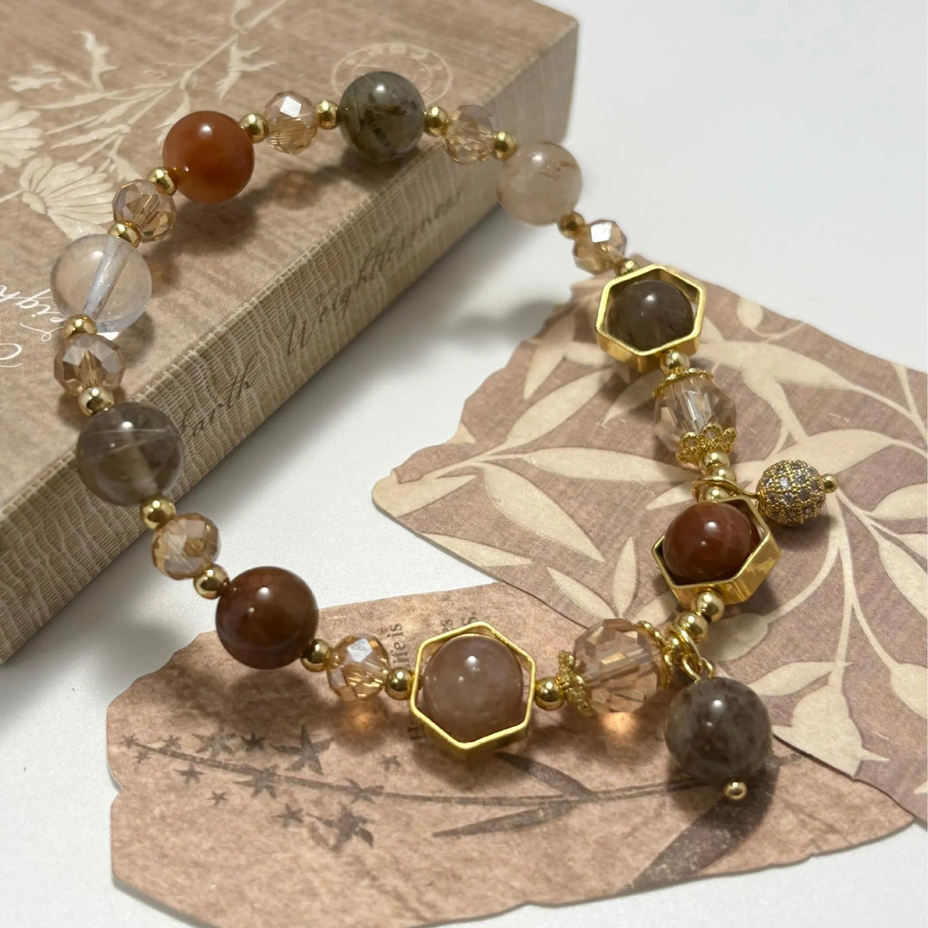 Gold citrine crystal bracelet with hand-woven construction showing auspicious Chinese symbols