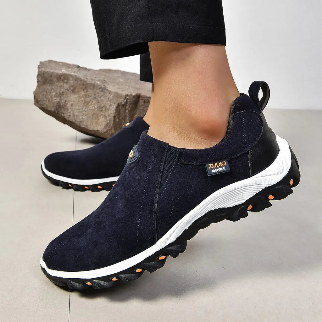 Men's thin oversleeve shoe cover in light brown with a round toe, shallow mouth, and rubber sole.