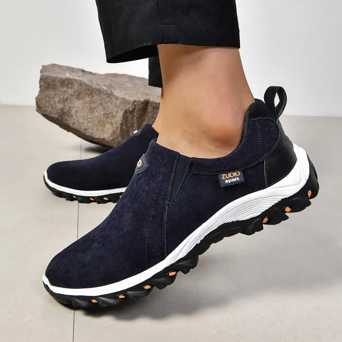 Men's thin oversleeve shoe cover in light brown with a round toe, shallow mouth, and rubber sole.