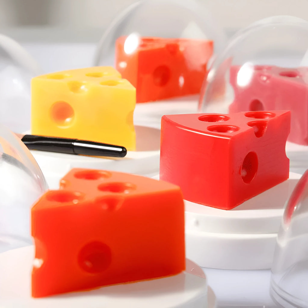 Pink cheese-shaped lip balm with Vitamin E and cream scent in open case with brush applicator