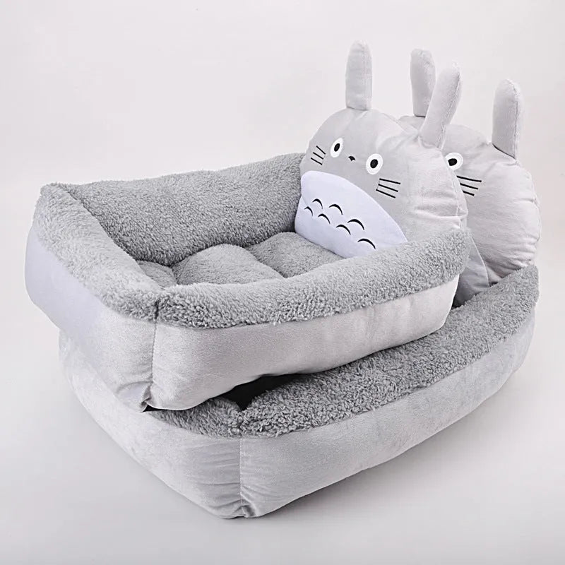 Blue sofa-style washable pet bed for a small dog on a wooden floor