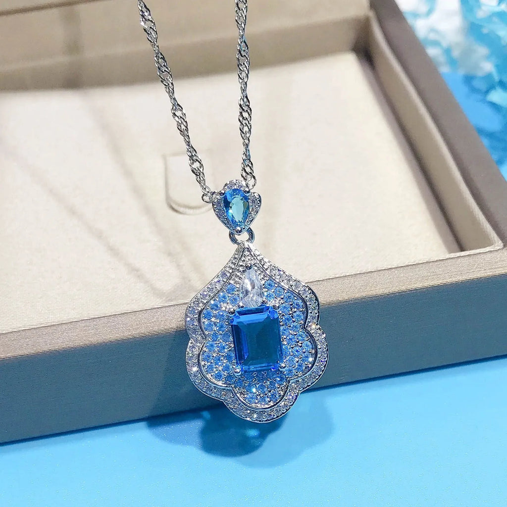 Sea blue geometric copper pendant charm with aquamarine topaz design, shown without a chain.