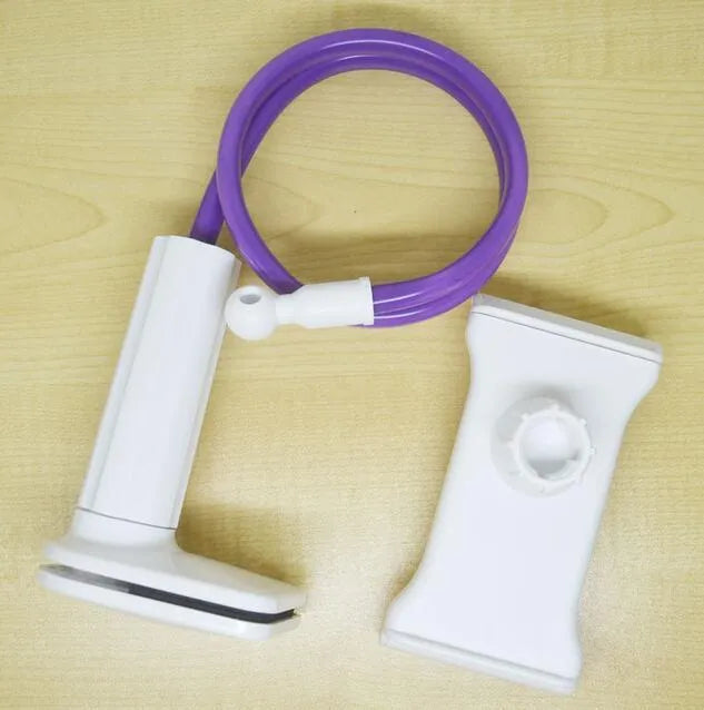 Black bedside phone handset with a long aluminium arm holding a mobile phone on a table.