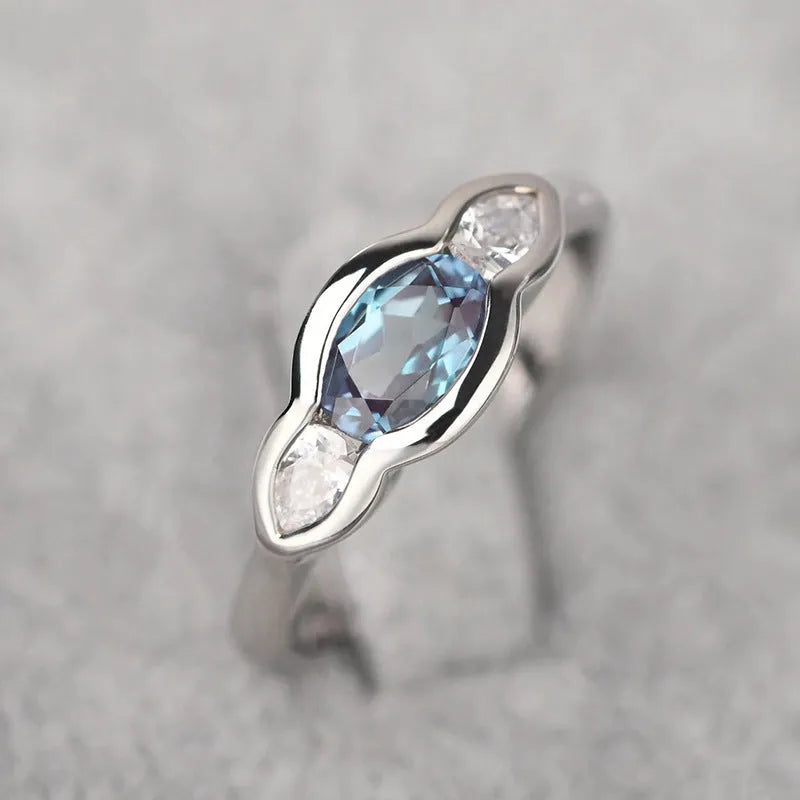 Geometric ellipse women's ring with zircon inlay in white gold finish, showing sizes 6 to 10