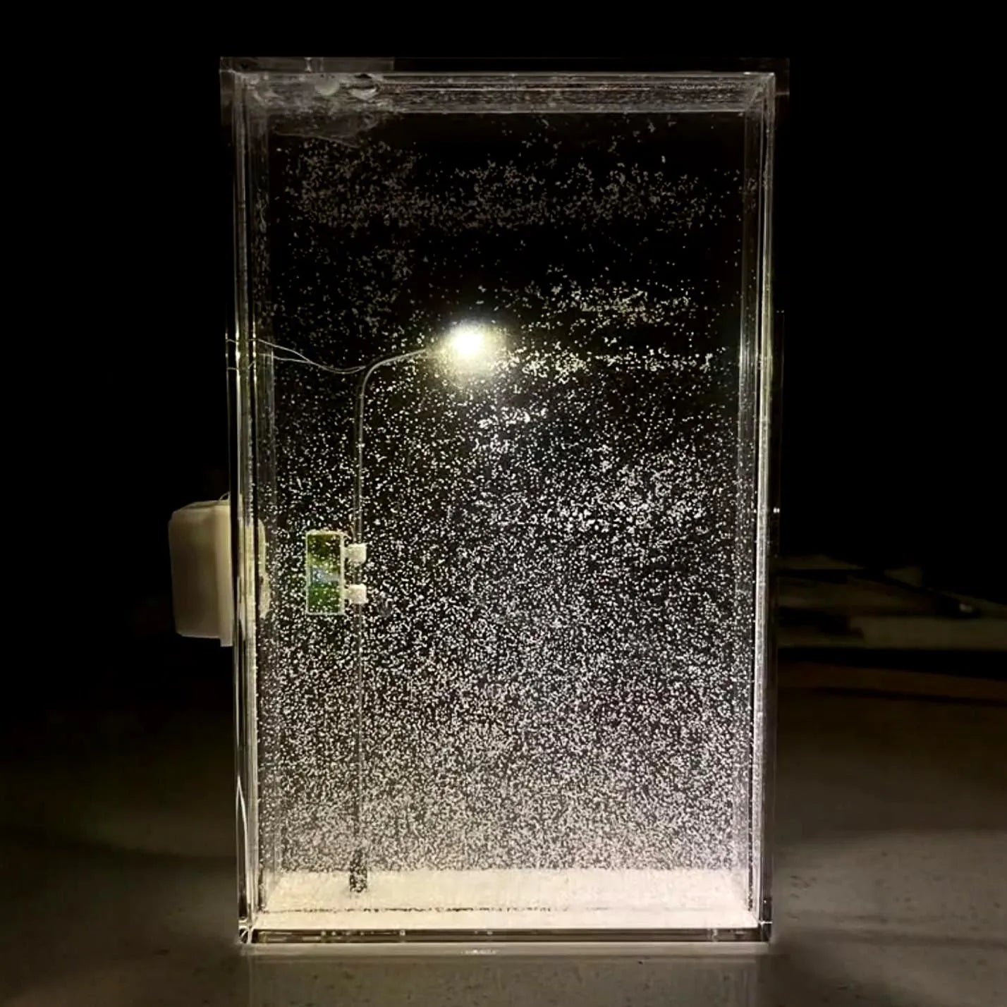 DIY kit for assembling a snowy landscape night light with LED effects on a desktop.