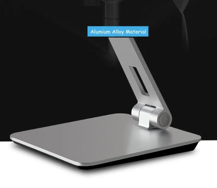 Silver foldable aluminium phone tablet stand with 360-degree rotating bracket on a desktop.