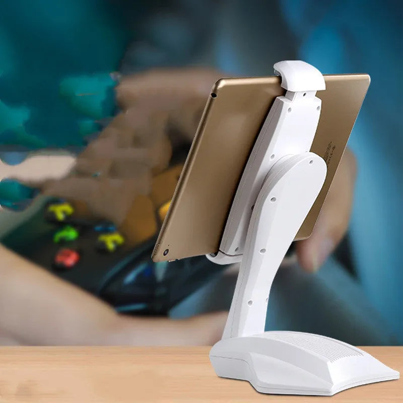 White adjustable tablet stand with a wide clip, holding a tablet on a table.