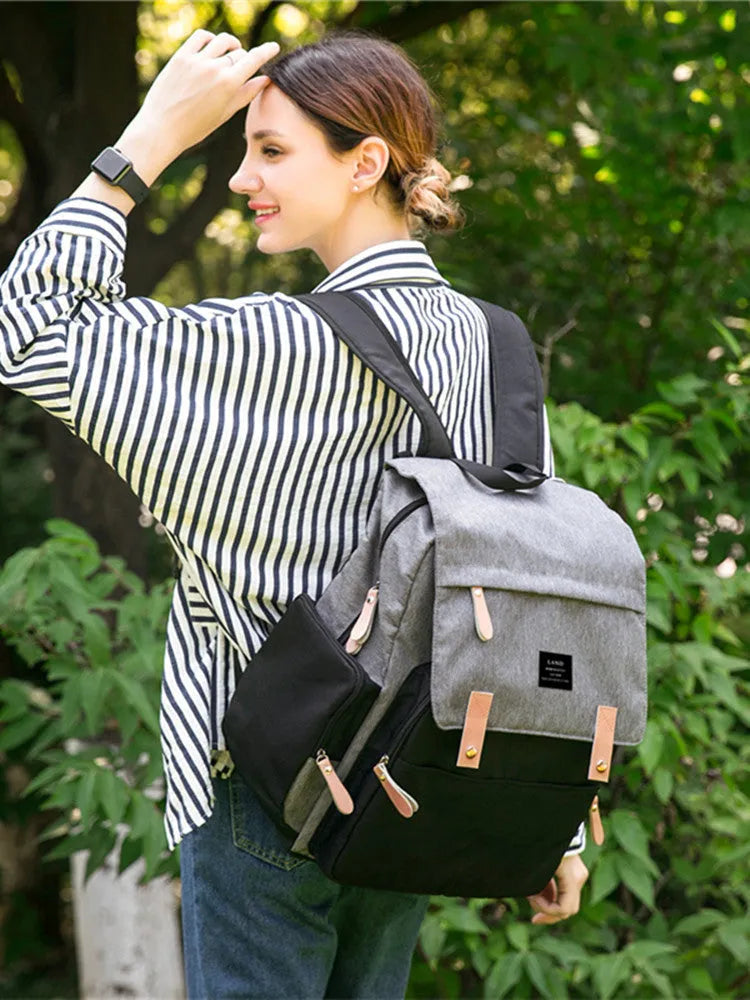 LAND Mommy Diaper Backpack in Oxford cloth with integrated changing mat, showing backpack straps and main compartment.