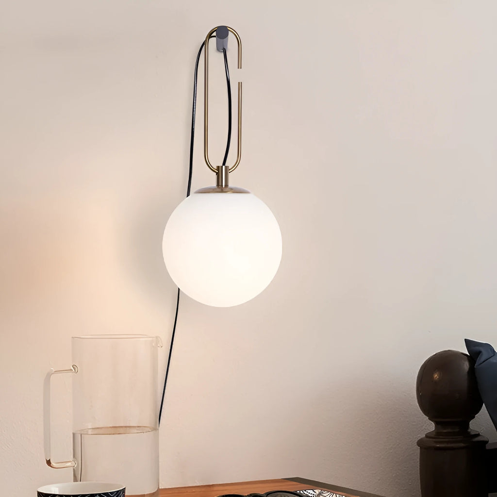 Modern clear glass wall lamp with European design showing three light colour options.