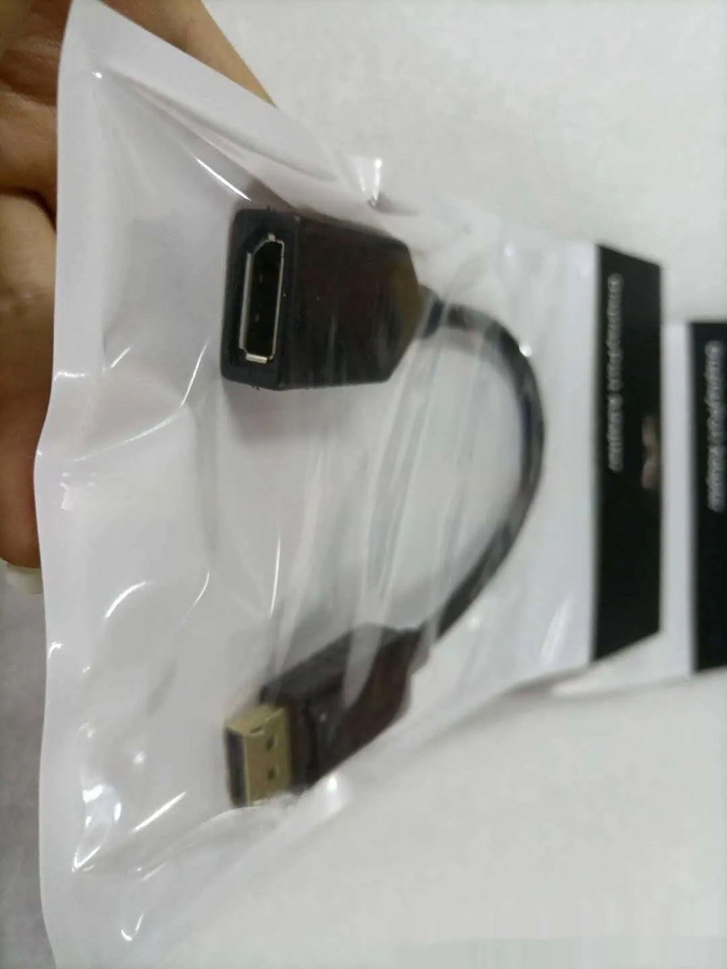Black DisplayPort DP male to female extension cable with rotating connector, approximately 10cm long