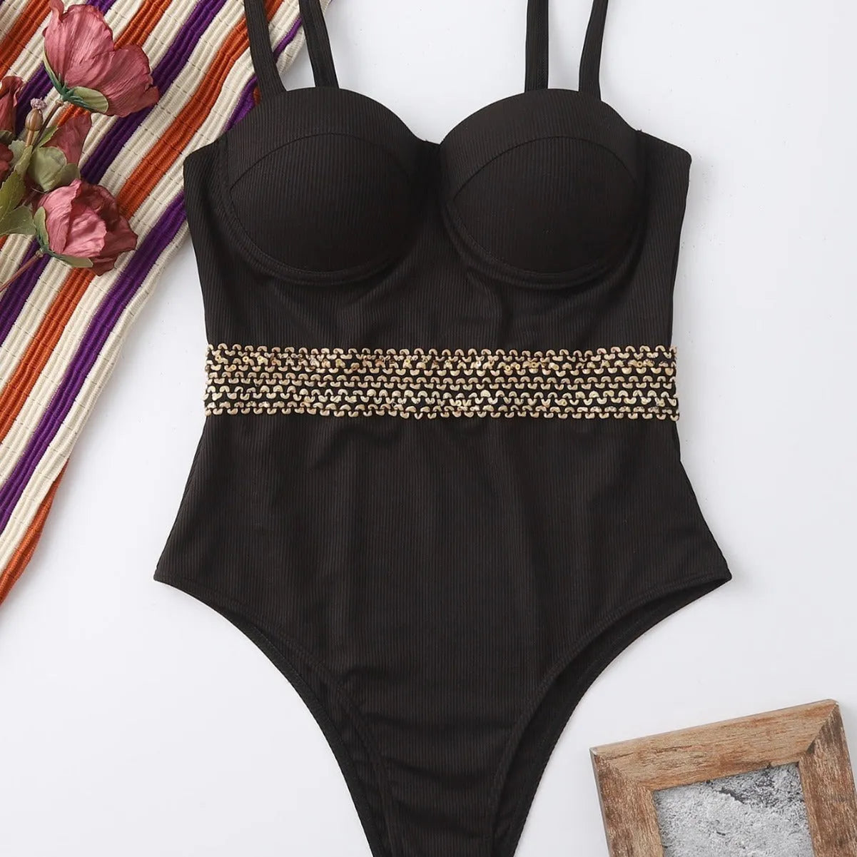 Black women's one-piece swimsuit with an adjustable shoulder strap on a mannequin