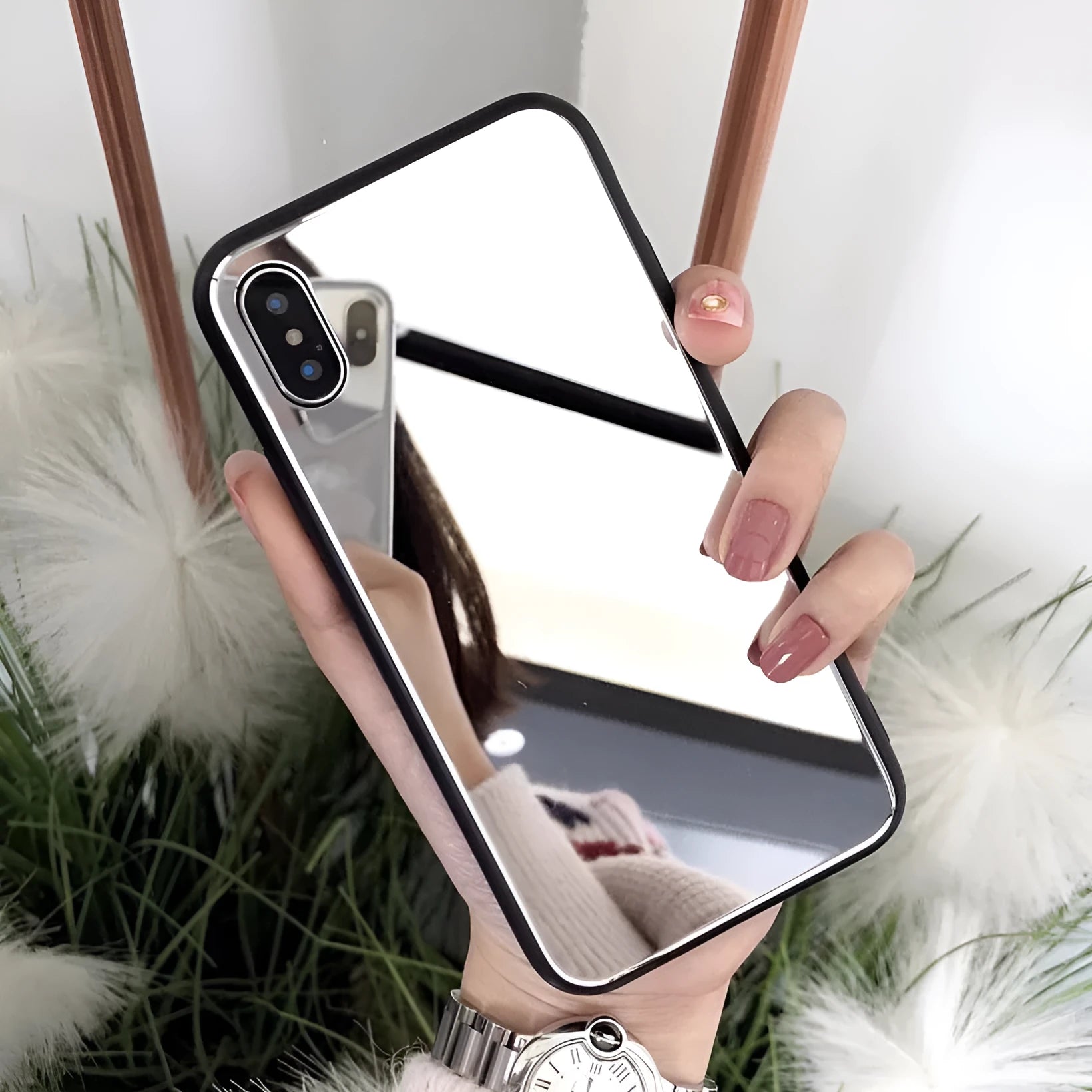 Black iPhone case with a reflective mirror surface on the back, compatible with multiple iPhone models.