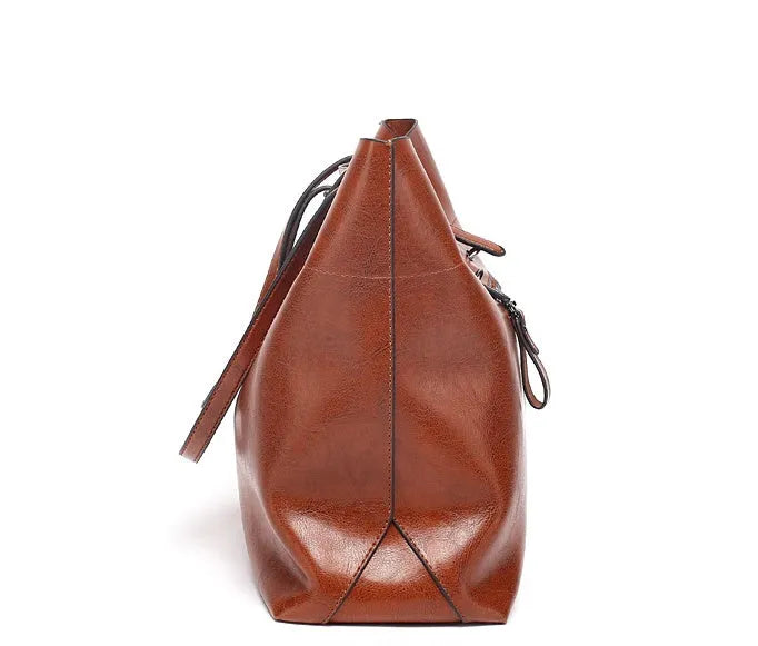 Horizontal brown cowhide leather crossbody handbag showing two main compartments and a front pocket.