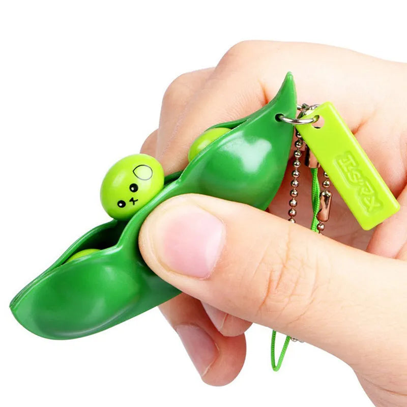Green soft PU decompression beans toy pendant shaped like a bean pod, designed for squeezing stress relief and hanging on phone or bag