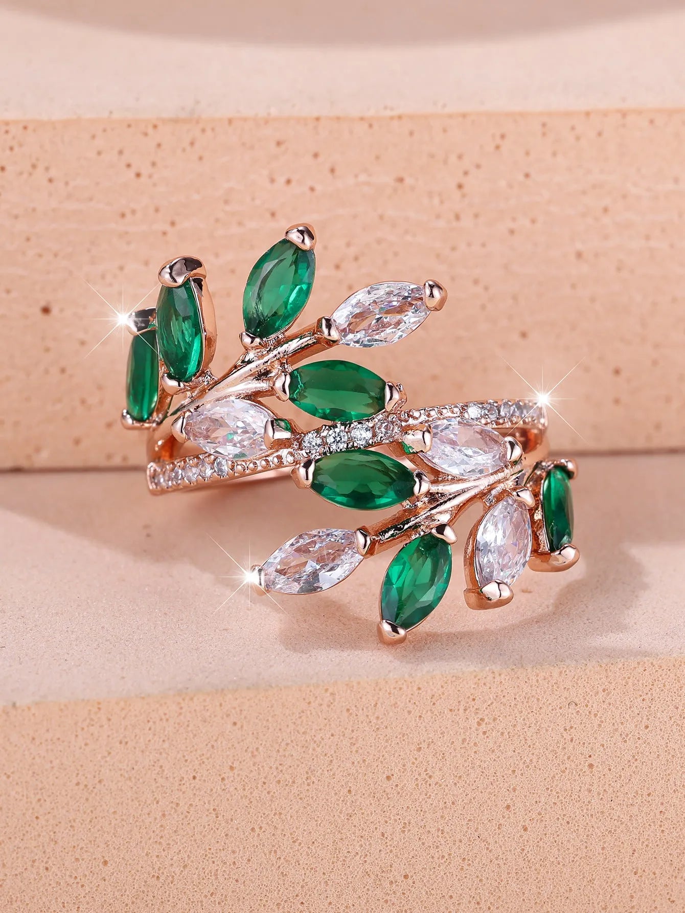 Adjustable copper ring with a detailed leaf design and zircon accents in various colour options.