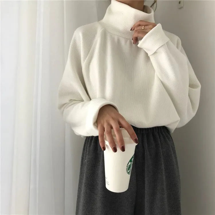 Women's loose fit long sleeve top with a half-high collar in white, apricot, or black.