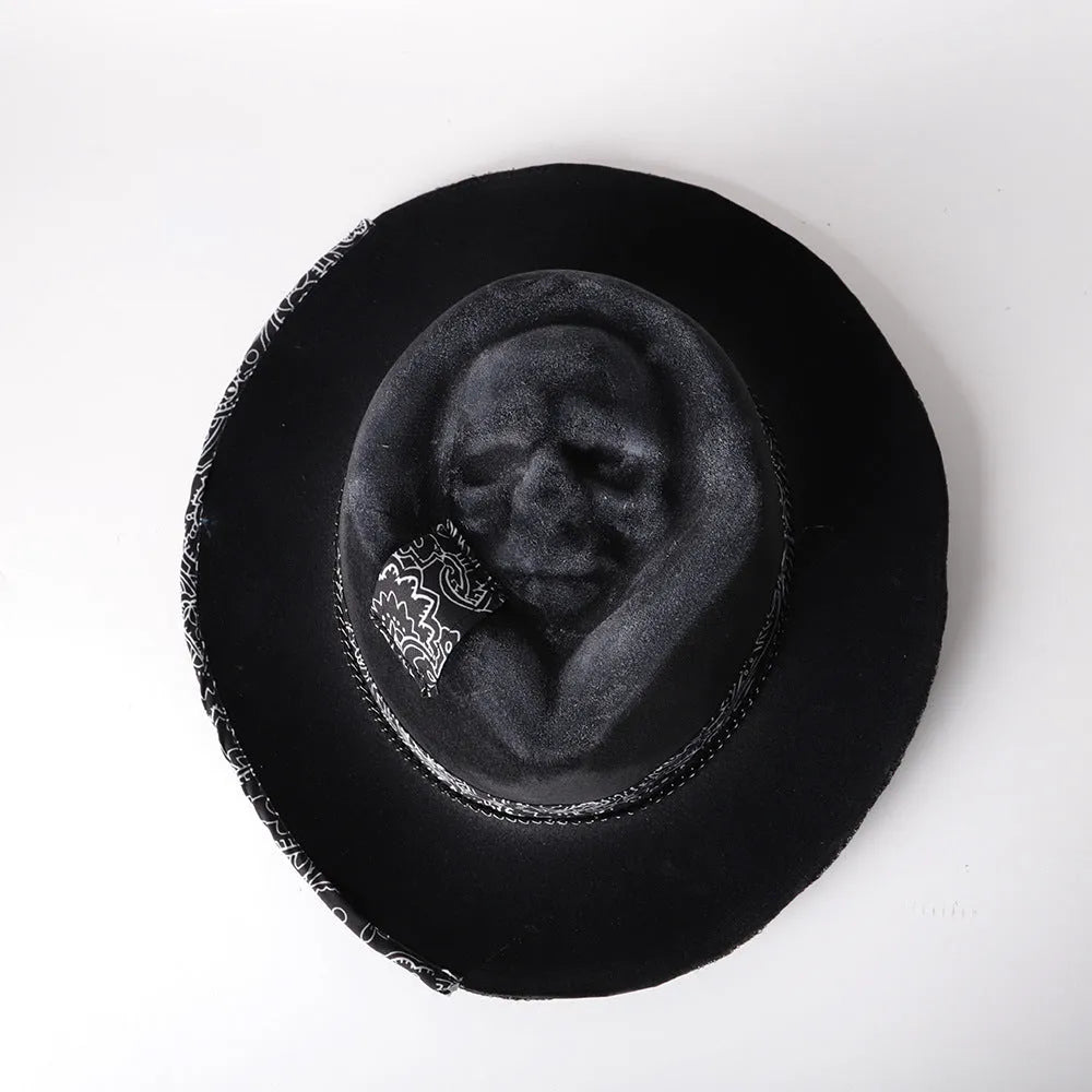 Handmade wool felt Halloween hat with a conical crown in a skull design.