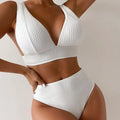 White women's backless two-piece bikini swimsuit set on a mannequin.