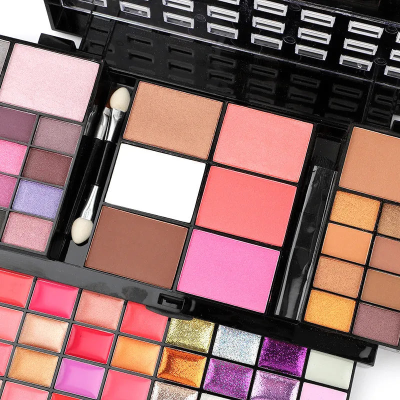 Four-layer 74 colour makeup palette with eyeshadow, lip gloss, and brushes in a plastic case.