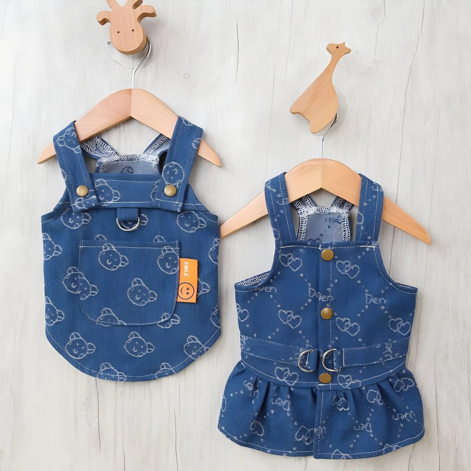 Small white dog wearing a light blue denim princess dress with a frilled skirt.