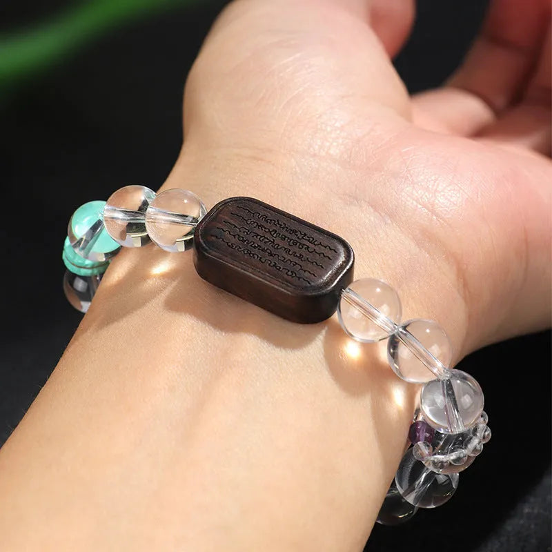 Handmade natural white crystal ebony bracelet with five warp design on wooden background