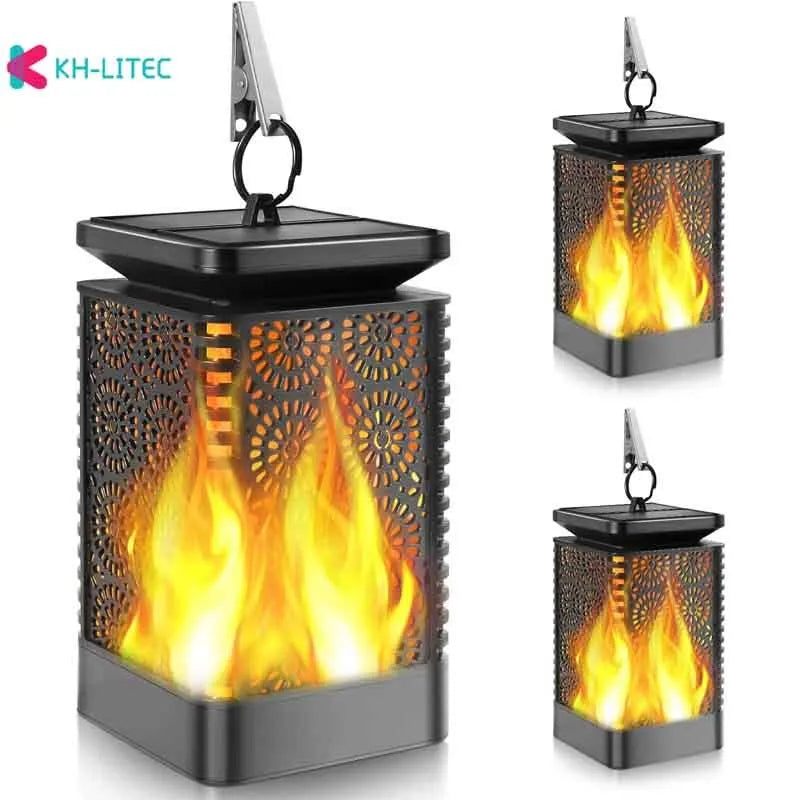 Four black solar-powered hanging lanterns with flame effect LED for garden decoration
