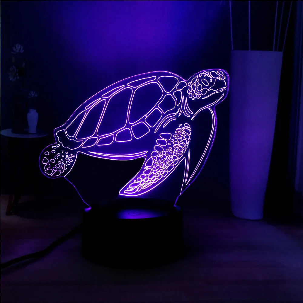3D green turtle-shaped LED night light with colourful glow, showing remote control and USB cable.