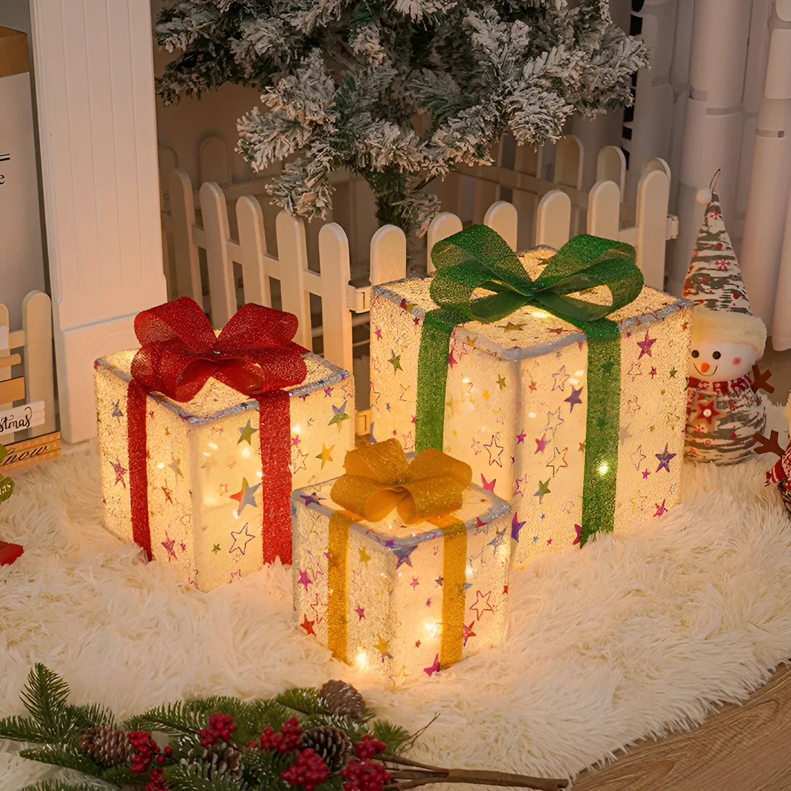 Set of three pre-lit Christmas gift box decorations with bows for outdoor holiday displays