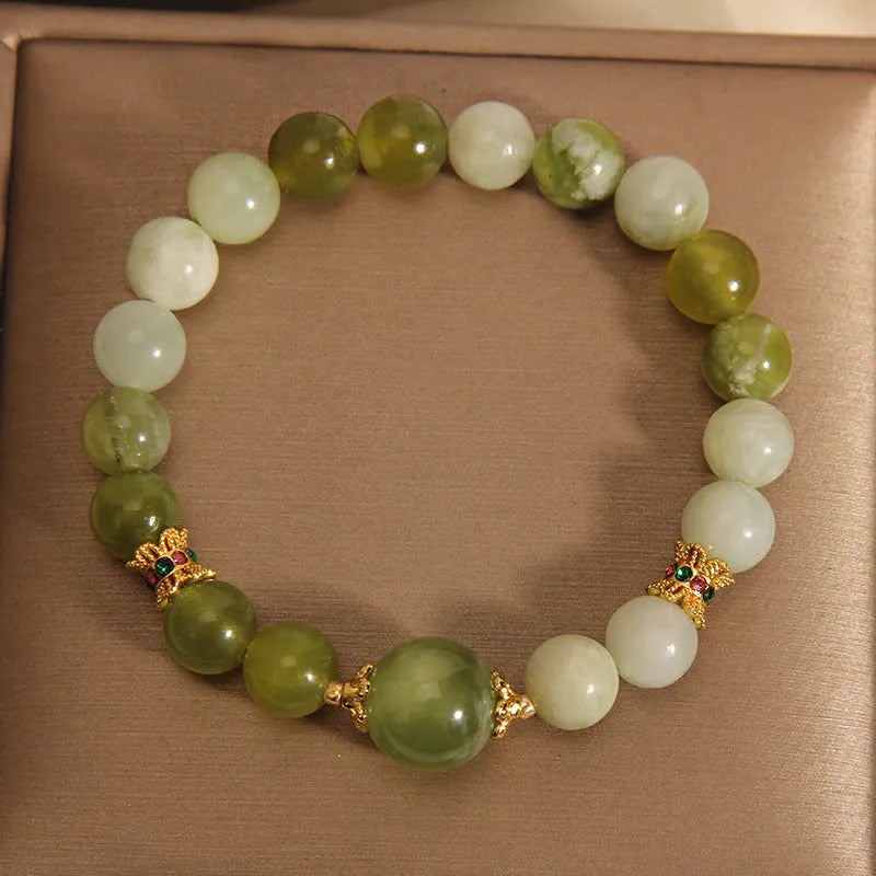 Women's solid Xiuyan jade bracelet in a green colour, shown as a single smooth bead.
