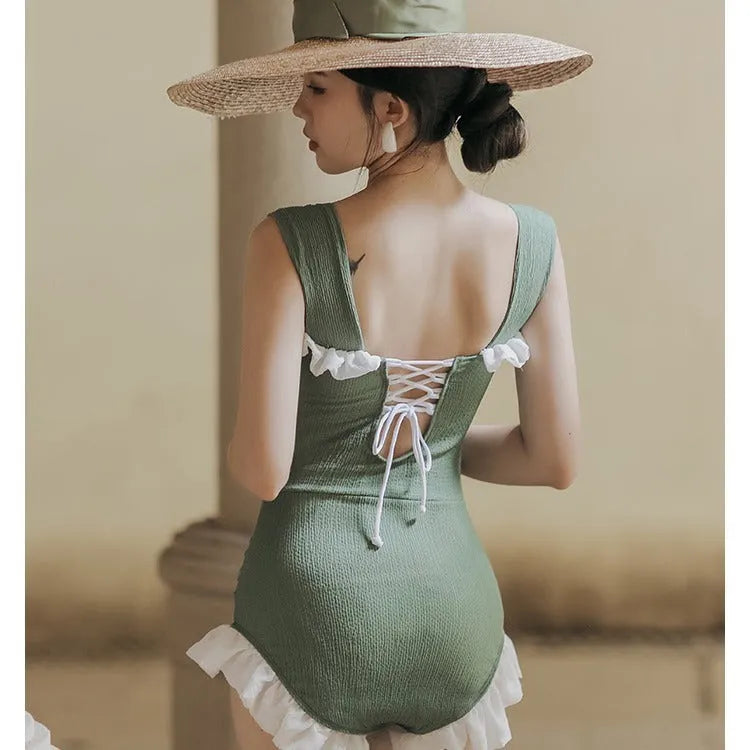 Women's high-waisted one-piece swimsuit in quick-dry polyester, shown in black, green, and pink.
