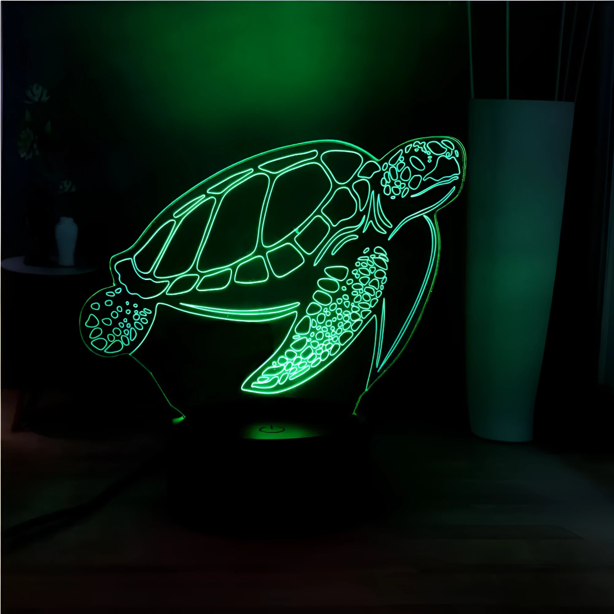 3D green turtle-shaped LED night light with colourful glow, showing remote control and USB cable.