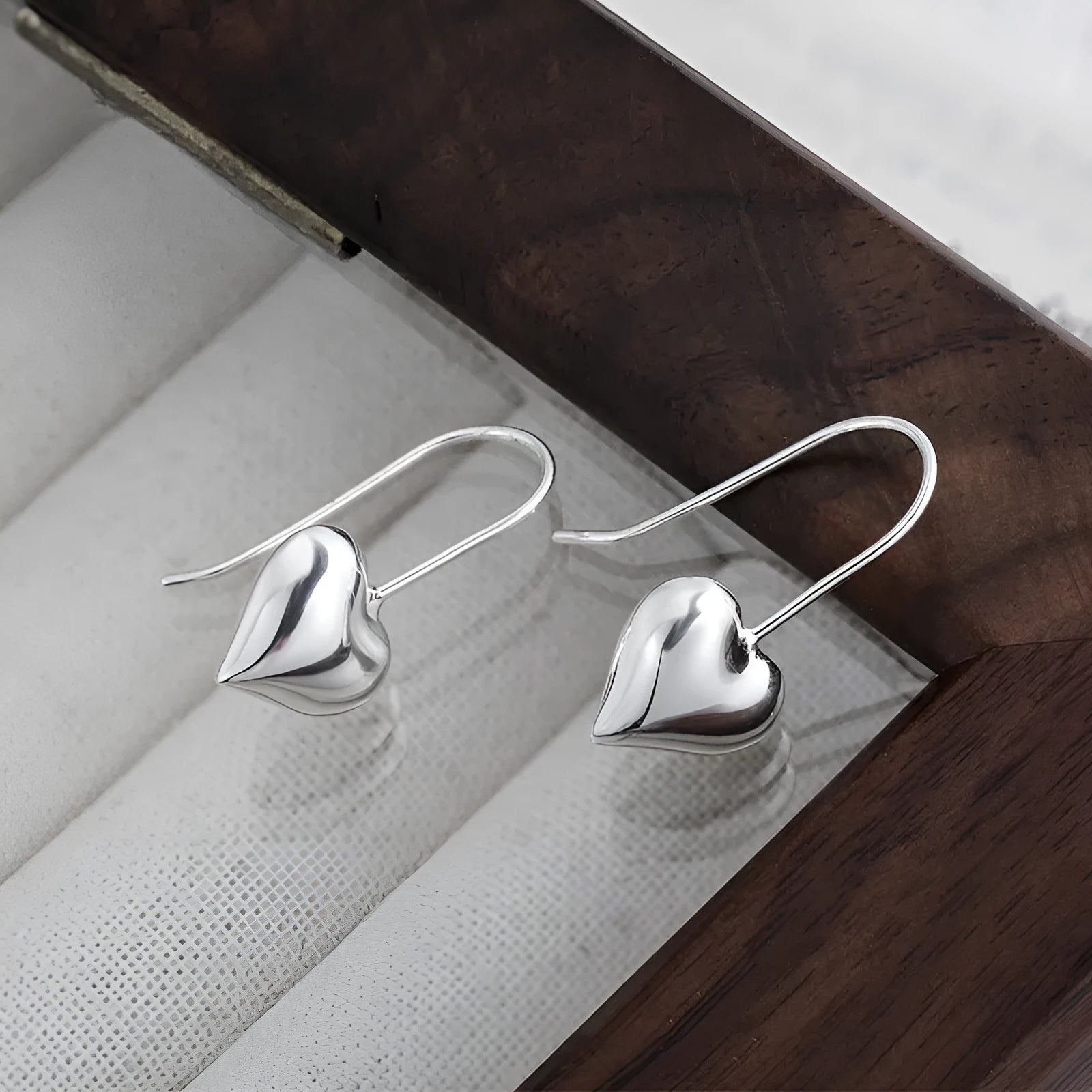Silver heart-shaped earrings with Korean style design and glossy finish
