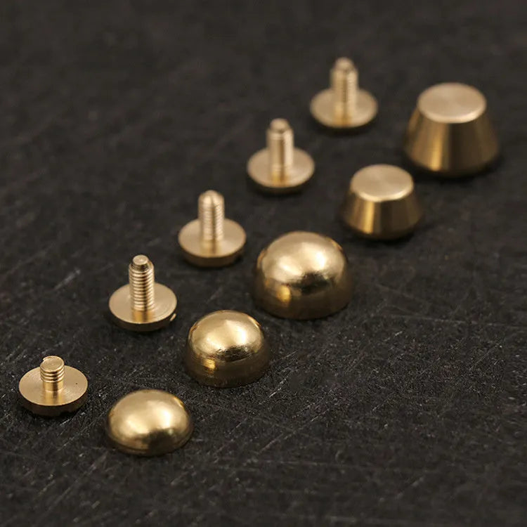 Assortment of brass decorative buckles in antique gold finish showing round foot nail and bucket foot nail designs