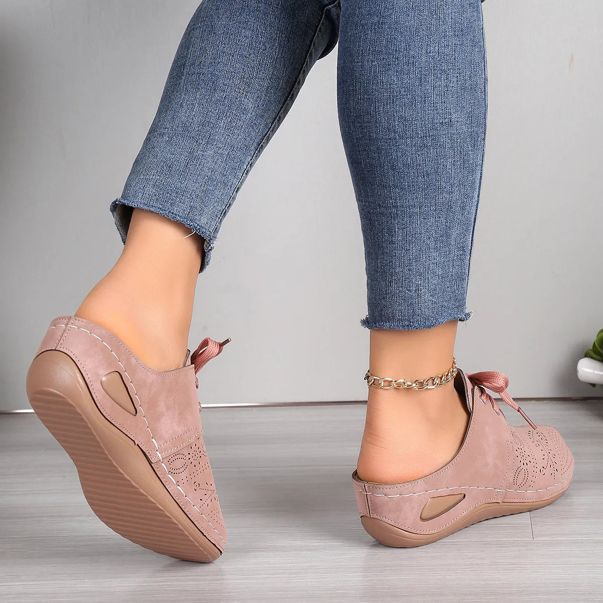 Women's suede lace-up wedge sandals in light grey showing hollow-out design and rubber sole