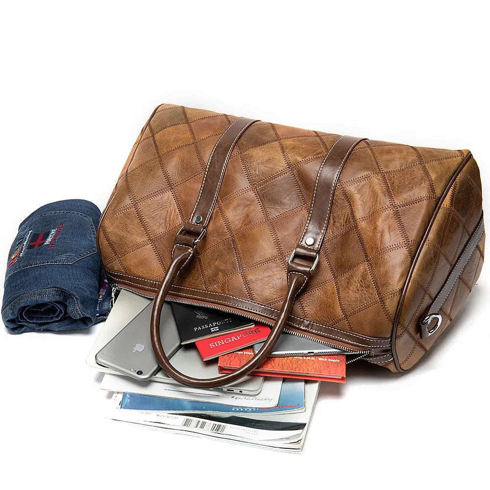 Vintage brown leather men's duffel bag with a single shoulder strap, shown open to reveal internal phone and ID pockets.