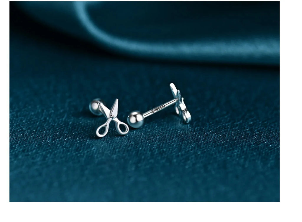 A pair of pure silver screw-style ear nails for cartilage piercings on a plain background.