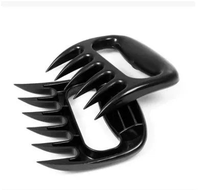 Two black bear claw meat shredding forks for barbecue preparation on kitchen surface