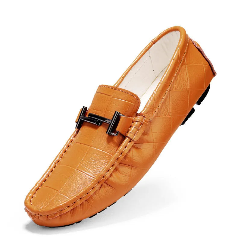 Men's brown leather loafers with silver buckle detail on low-cut design