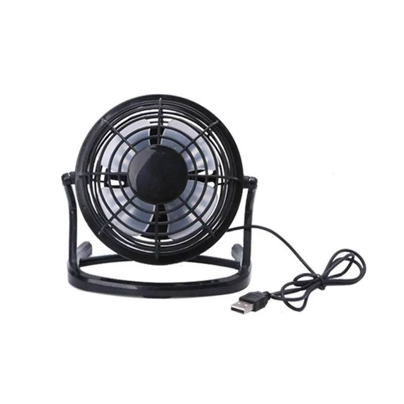 Mini portable USB desk fan with adjustable angle in black colour beside laptop